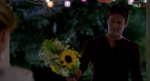 Bill Compton (Stephen Moyer) offers Sookie Stackhouse (Anna Paquin) some flowers in HBO's True Blood Season 7 Episode 5 (entitled 'Lost Cause')